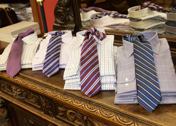 A couple of different design shirt suit ties stacked on a table